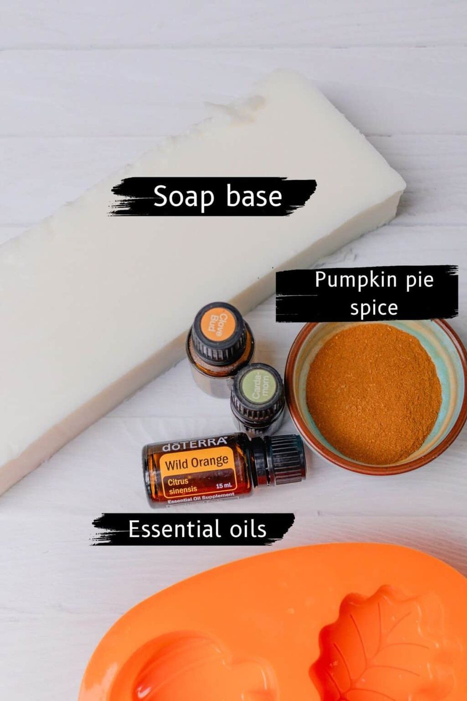 Pumpkin soap ingredients on a white counter.