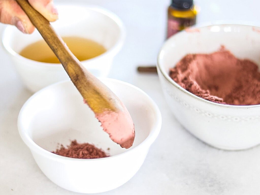 Measuring rose clay into a bowl.