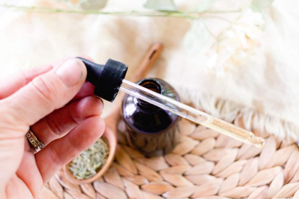 A dropper with a bottle of Rosemary oil.