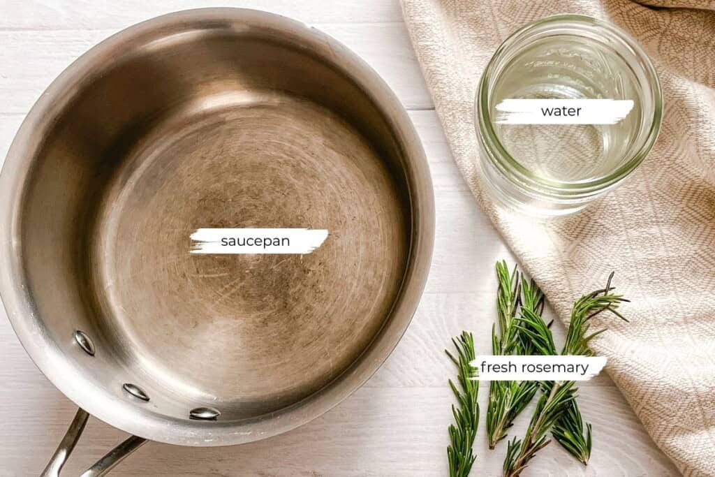Ingredients for the rosemary water measured out on a white, wooden table.