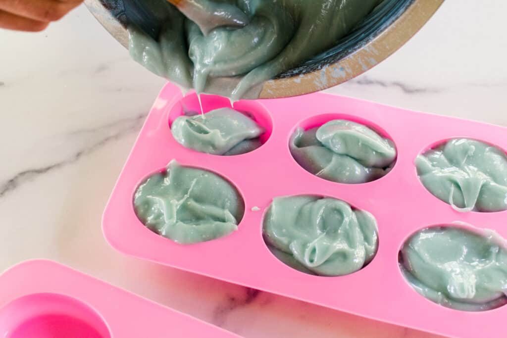 Pouring sea salt soap mixture into soap molds.