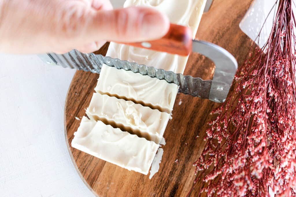 Cutting shea butter soap into soap bars.