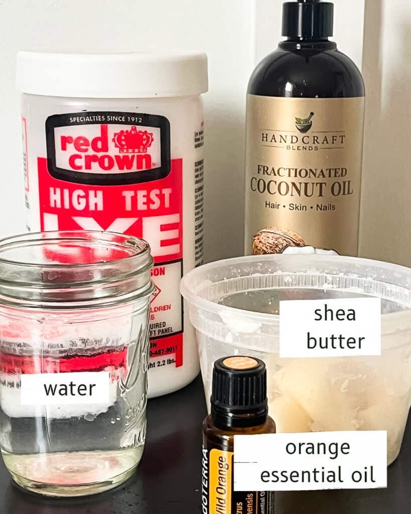 Ingredients to make shea butter soap laid out on a wooden table.
