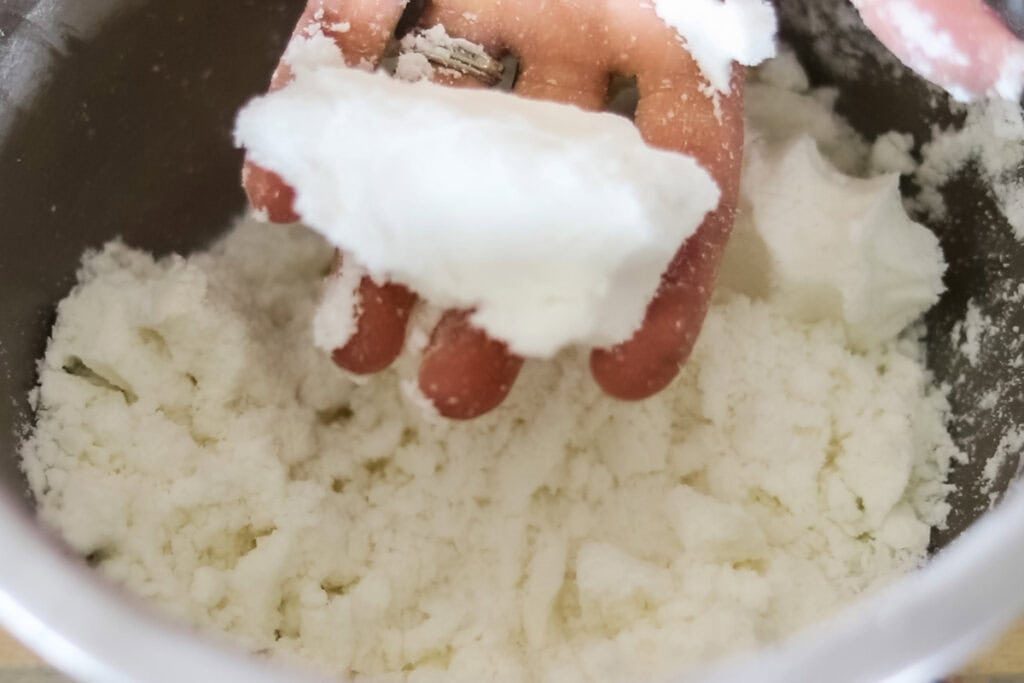 Misting the ingredients to get the correct texture and checking it with our hands.