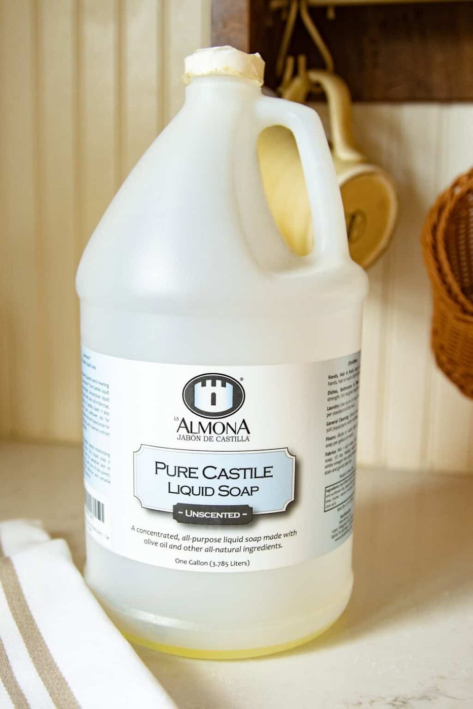 A gallon jug of castile soap on a kitchen counter.