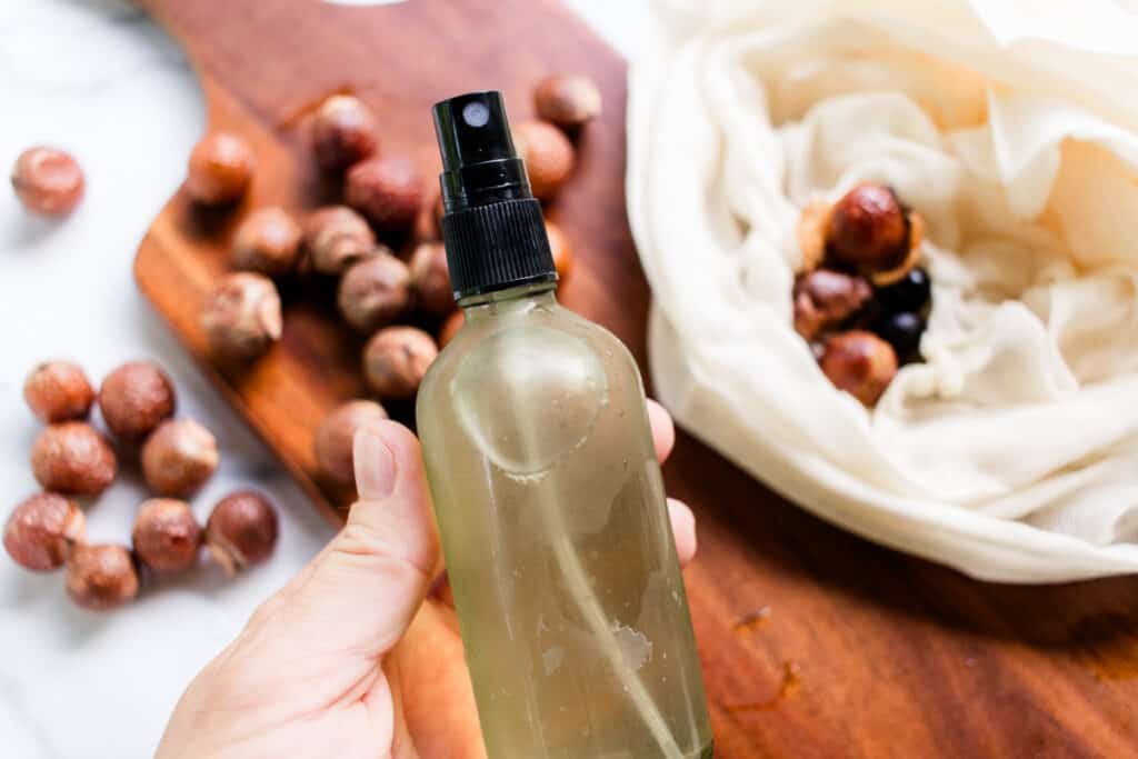 Getting ready to spray a homemade soap nut shampoo into our hair.
