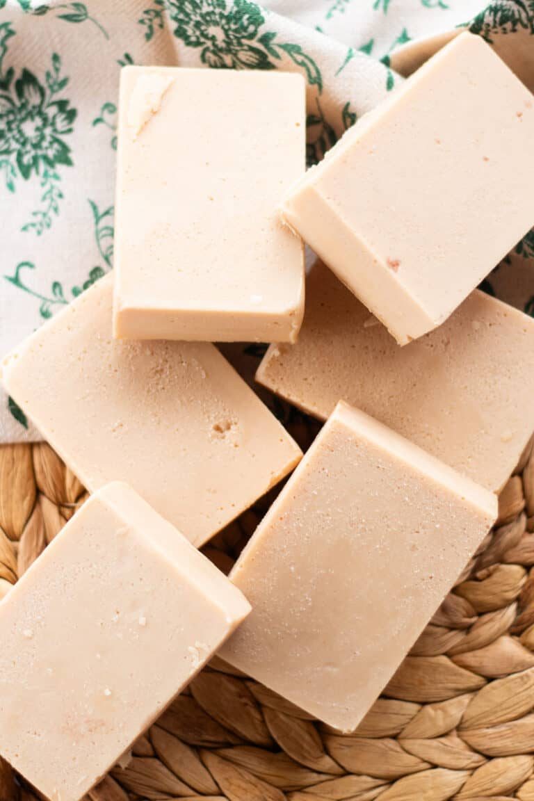 Six bars of DIY soap bars on a woven placemat.