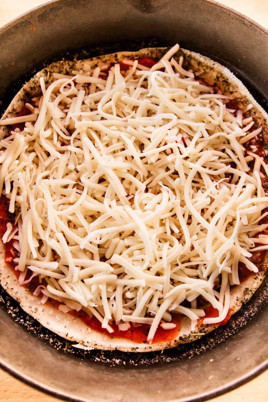 Sourdough pizza crust with sauce and cheese.