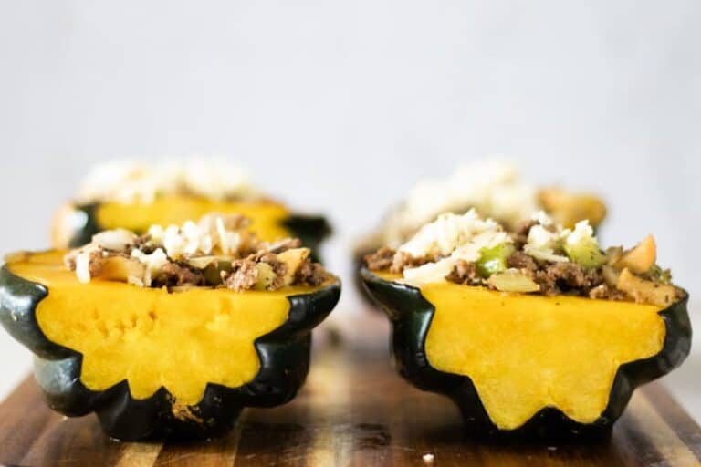 stuffed acorn squash on wooden cutting board