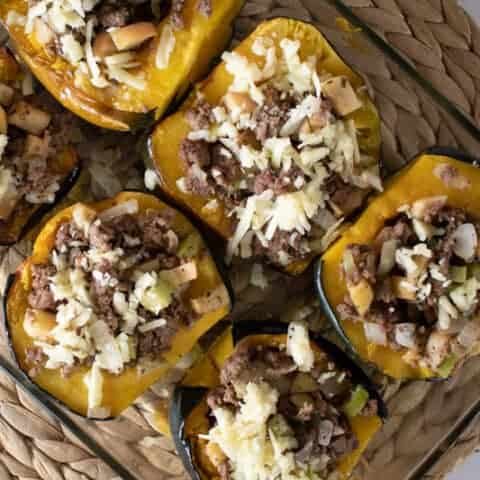 stuffed acorn squash in glass baking dish