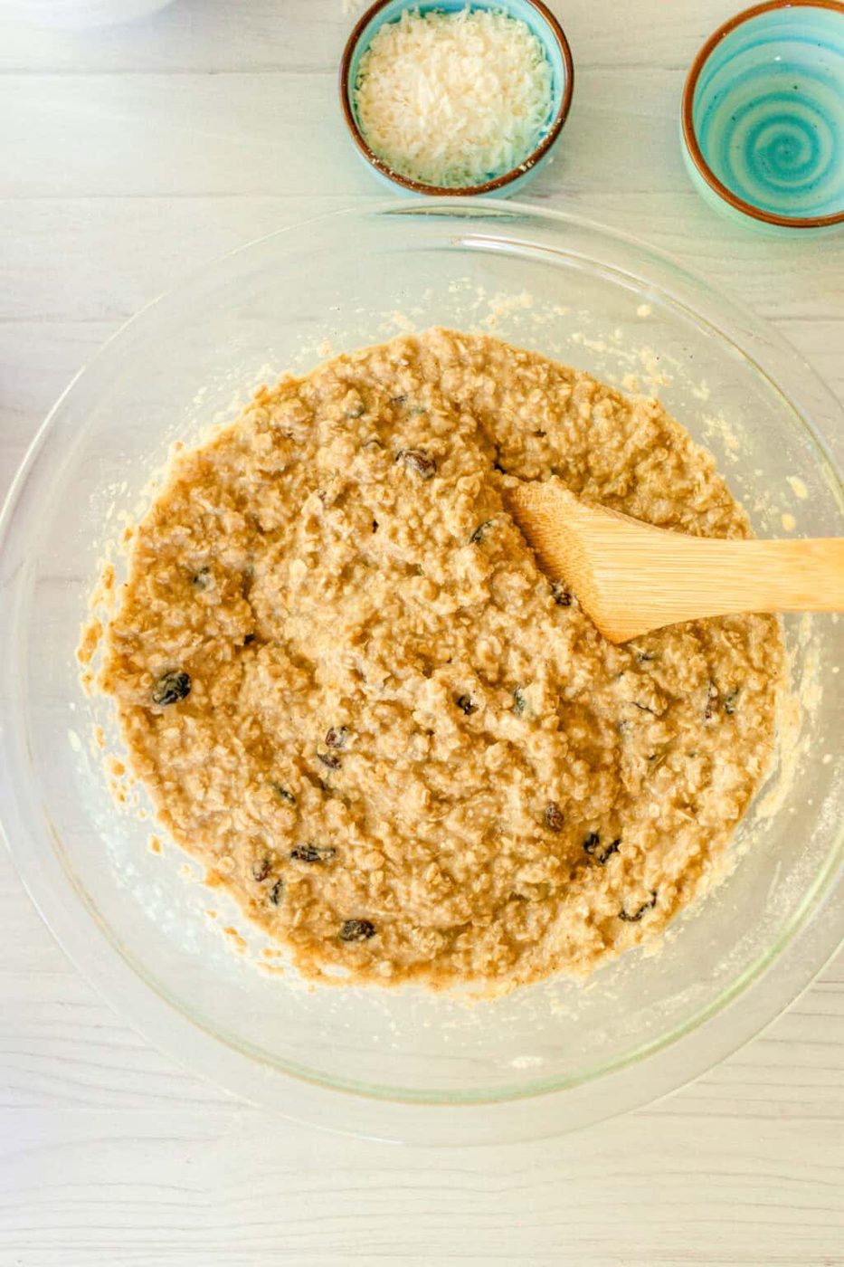Stirring the raisins into the batter with a wooden spatula.