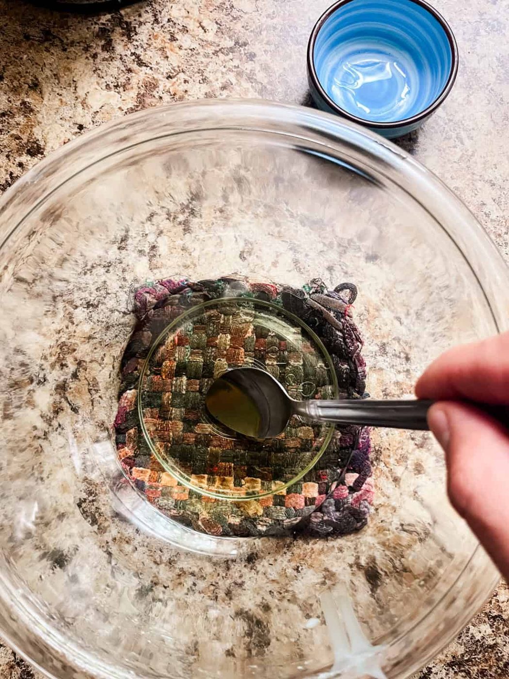 Stirring a bowl of melted tallow lip balm ingredients.
