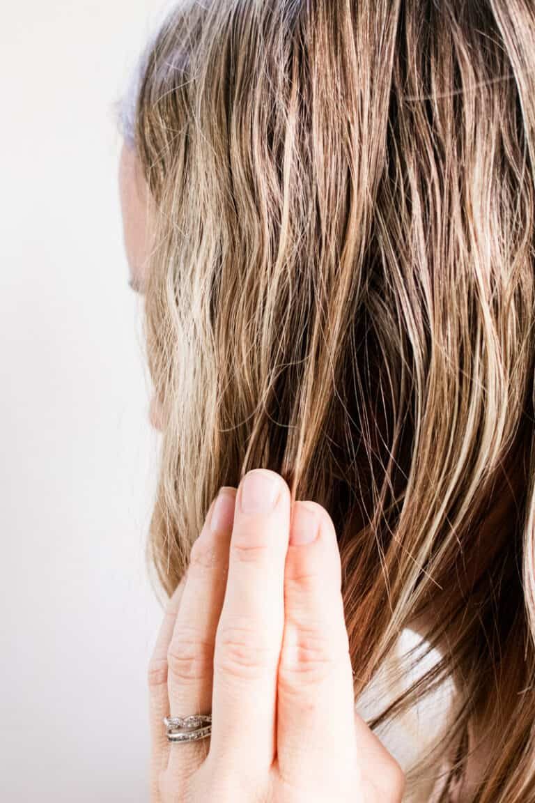 Applying hair moisturizer oil.