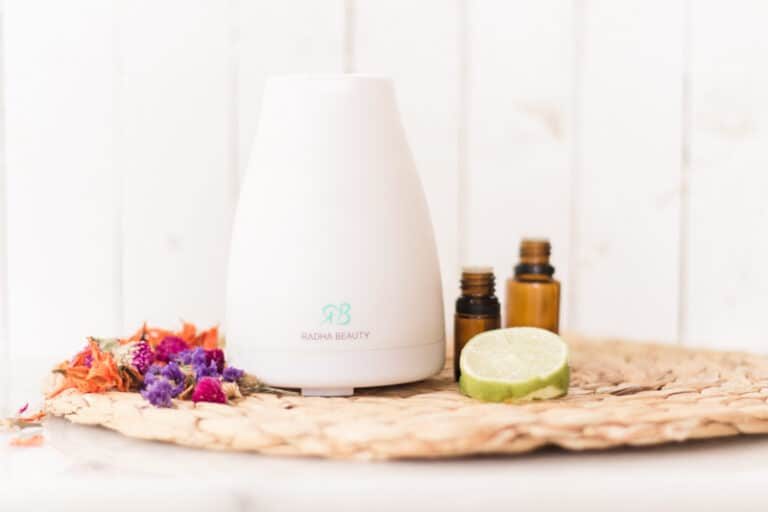 Diffuser with tropical oils and sliced limes.