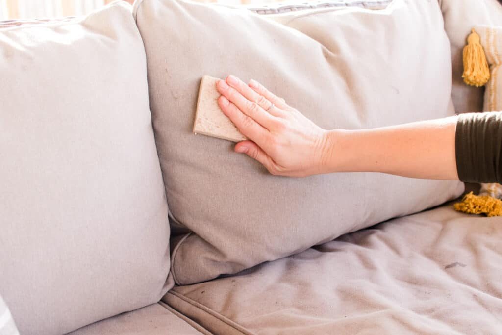 Wiping upholstery with a cloth.