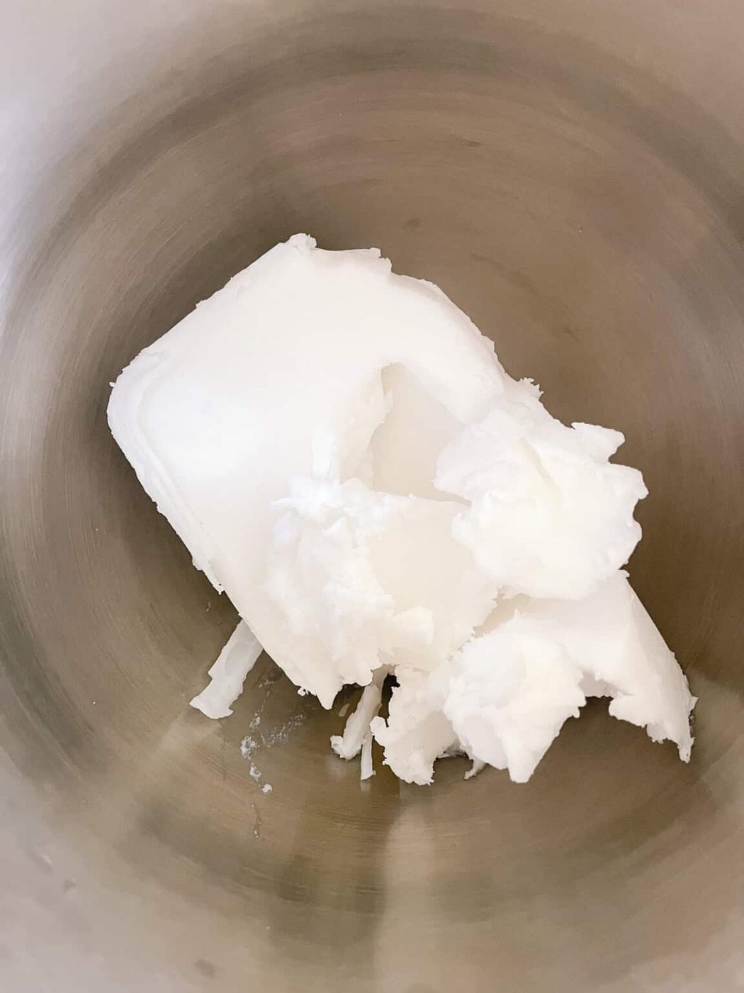 Soap base in a metal mixing bowl.