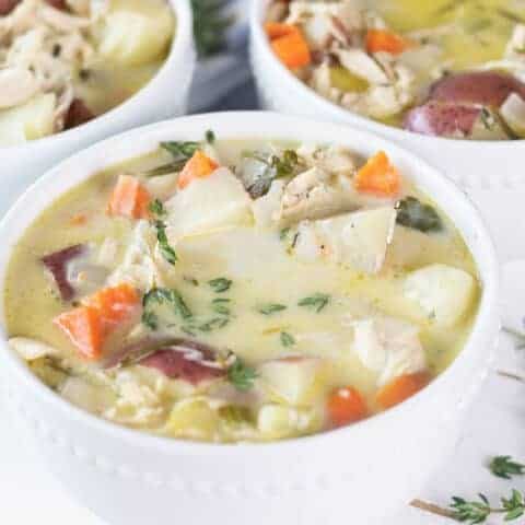 three white bowls of creamy chicken soup