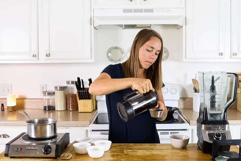 Pouring coffee into a measuring cup.