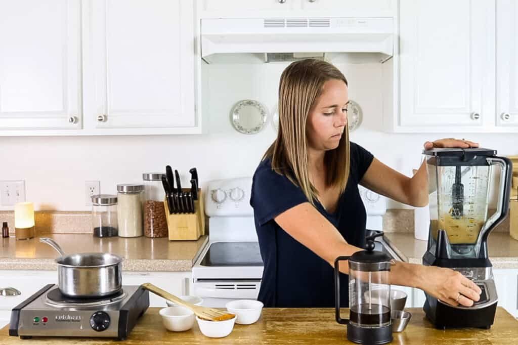 Blending a pumpkin spice latte in a stand blender.