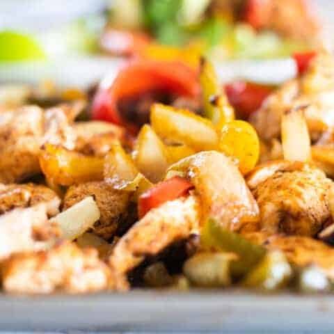 Fajita chicken and peppers on sheet pan.