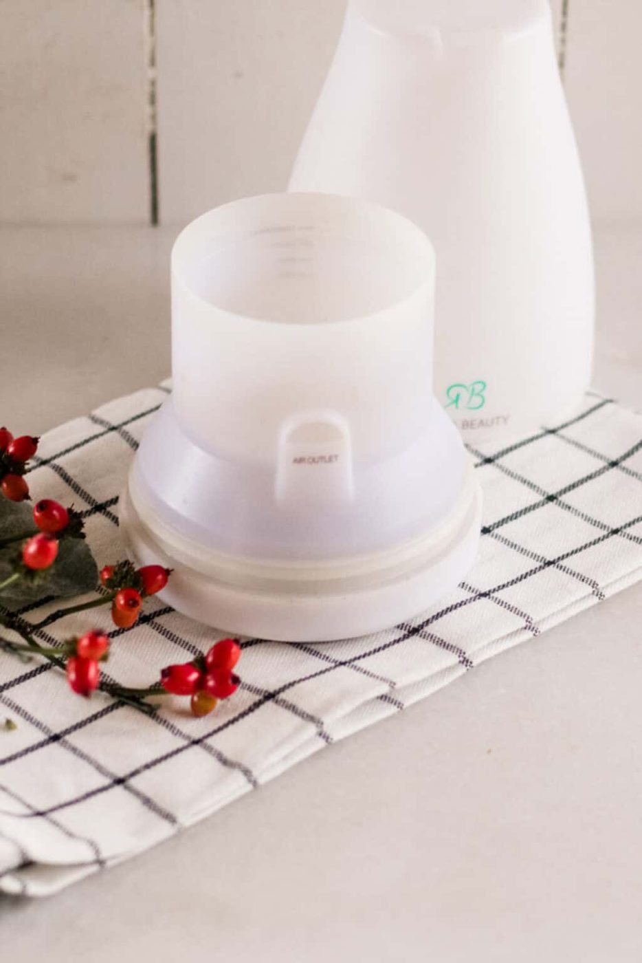 A diffuser on a plaid towel.