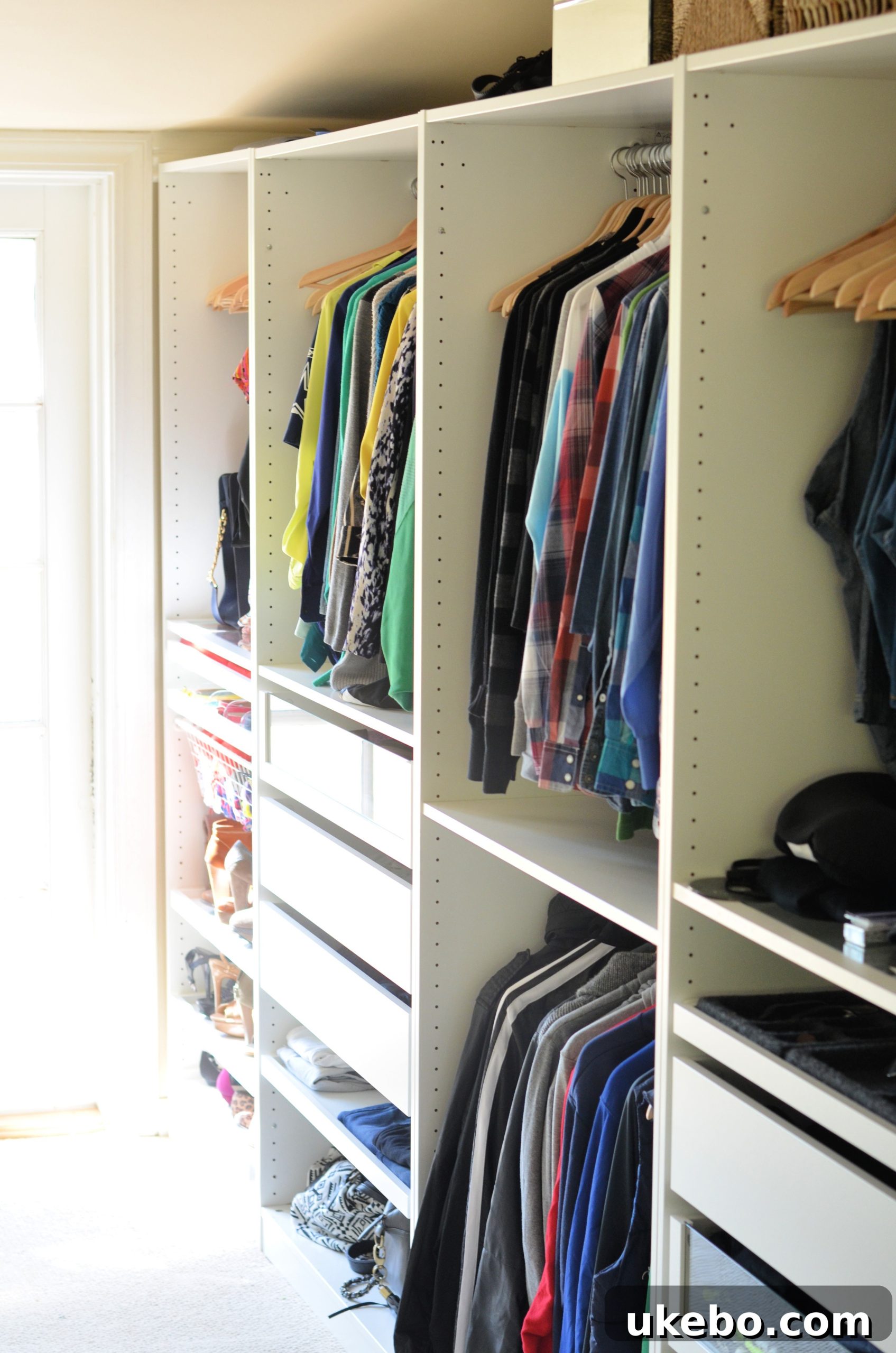 Open IKEA PAX closet system with clothes and accessories