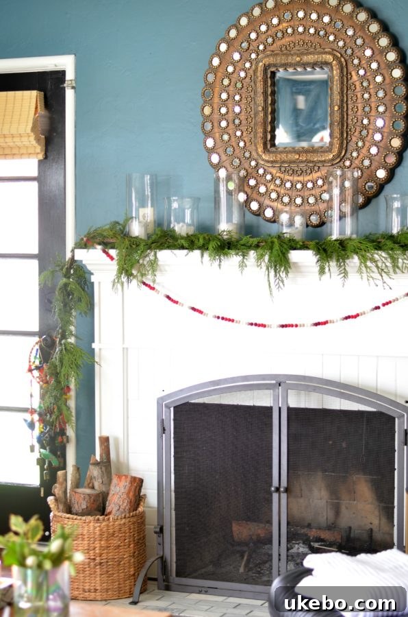 Elegant holiday mantel decor with fresh garland and candles