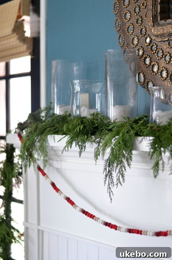 Close-up of holiday mantel decor with fresh greenery