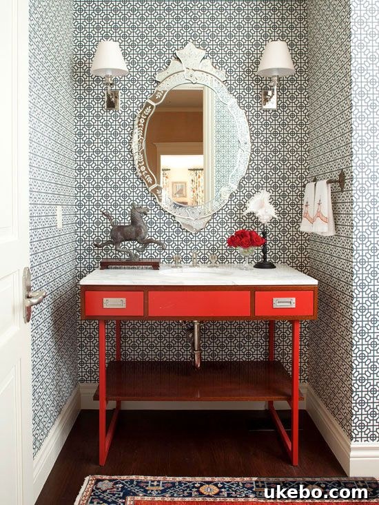 Luxurious bathroom featuring a large statement mirror and elegant furnishings.