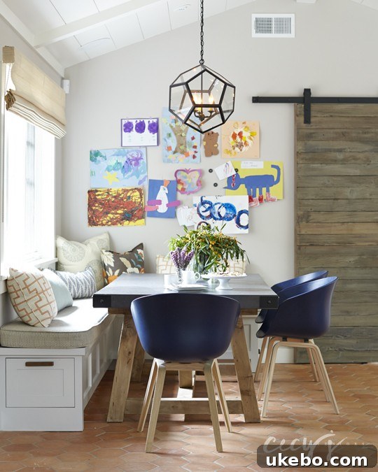 Chic dining area with banquette seating in a Los Altos Bungalow designed by Cecy J Interiors