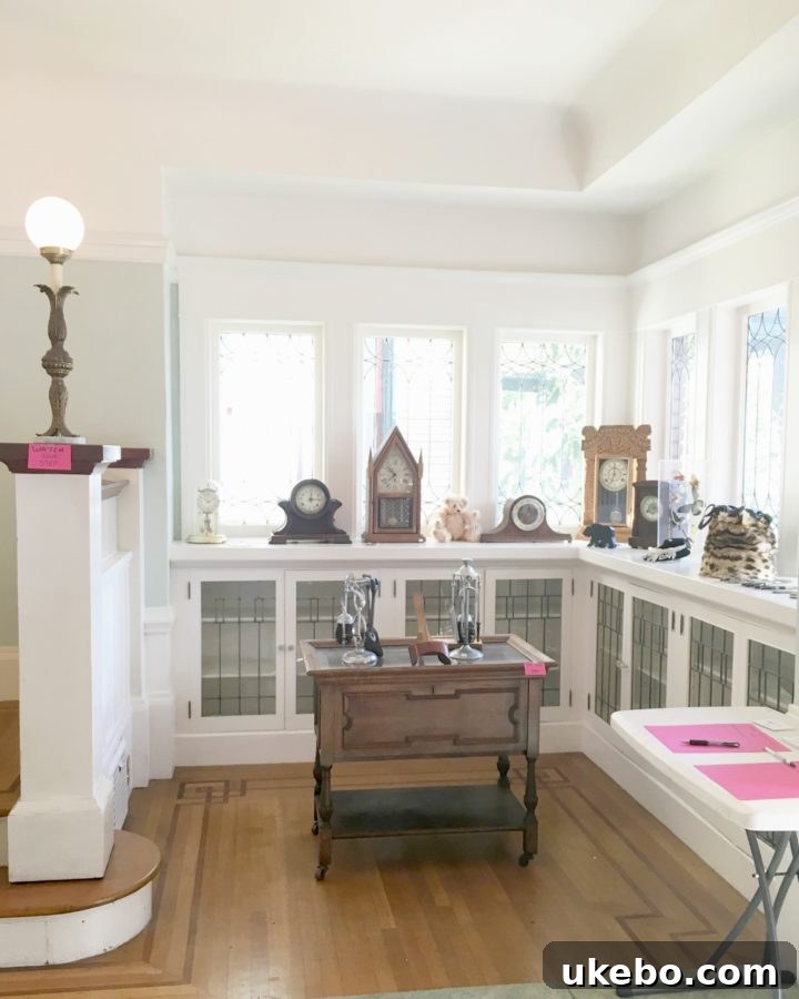 Elegant grand staircase and vintage architectural details in an early 1900s home, bathed in natural light