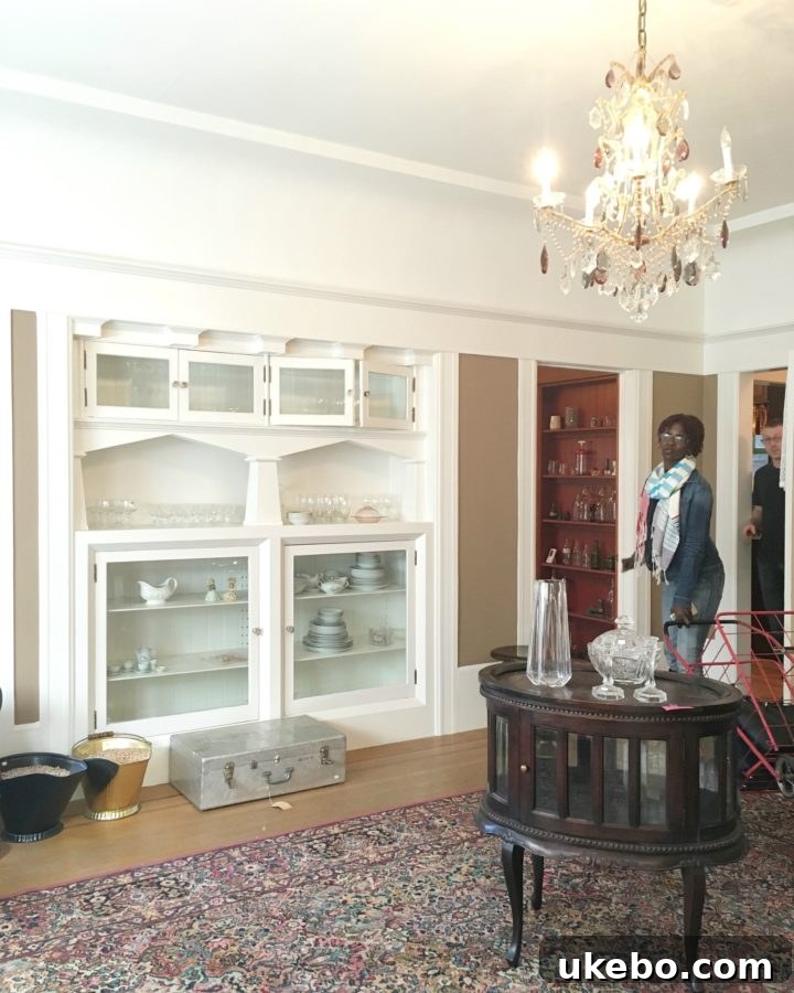 A sun-drenched hallway showcasing original hardwood floors, high ceilings, and period details