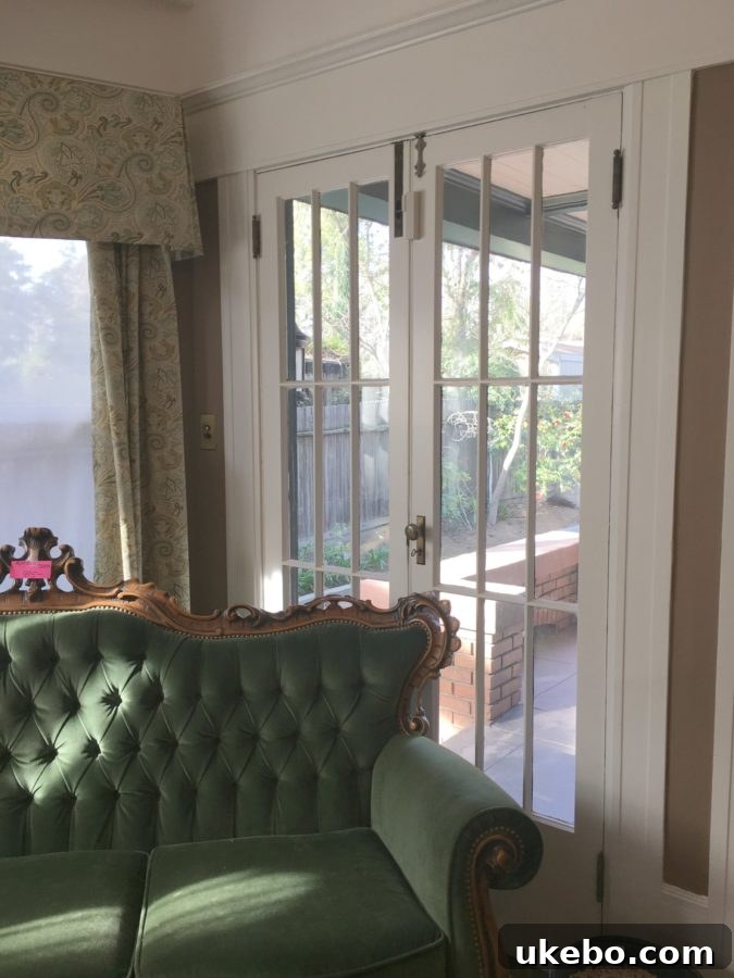 Our Downsizing Journey A Moment of Clarity 6 Interior view of a spacious living area with carefully curated vintage furniture and ample natural light