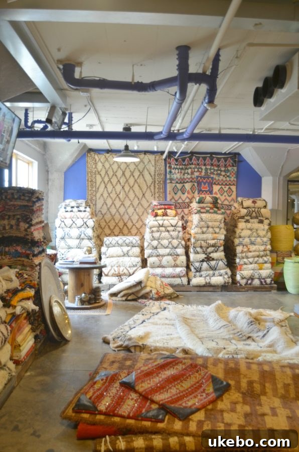 Interior view of Kechmara Designs showcasing various Moroccan rugs and decor