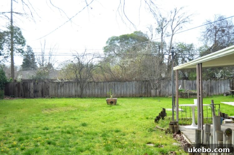 Old, dilapidated wooden fence posts and panels, showcasing the urgent need for replacement in a Sacramento bungalow garden.