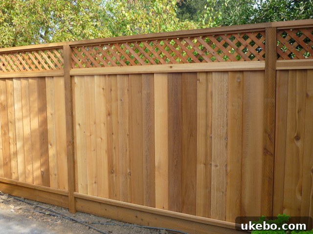 Refreshing the Cottage Bungalow's Fence Line 17 Traditional wooden fence with a decorative lattice top, offering classic charm and partial privacy for a home.