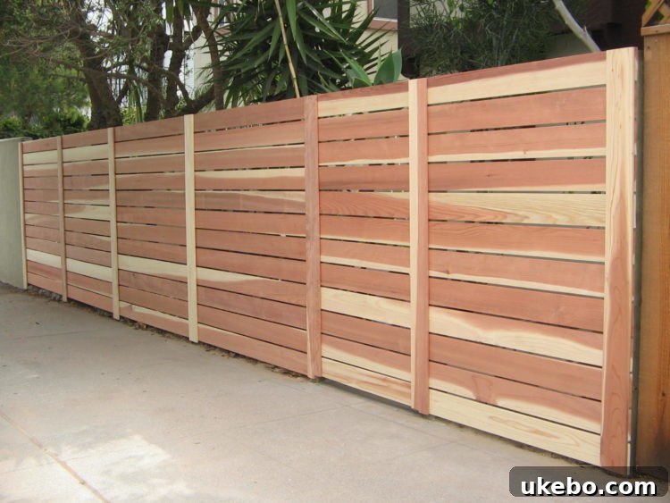Modern horizontal slat fence, showcasing a sleek, contemporary design popular for its clean lines in modern landscapes.