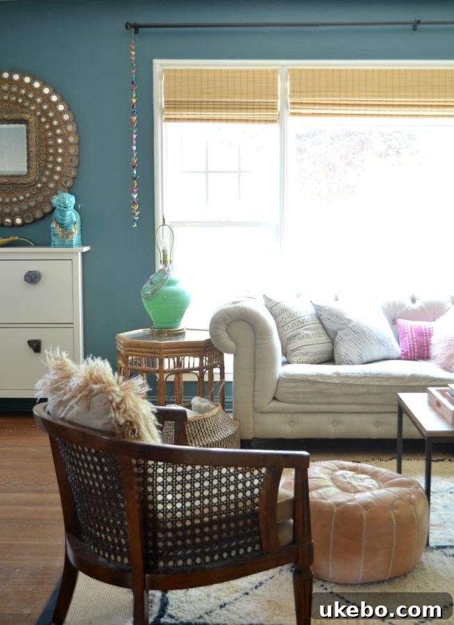 A close-up of a vibrant corner in the living room, featuring art, plants, and an array of textured cushions.