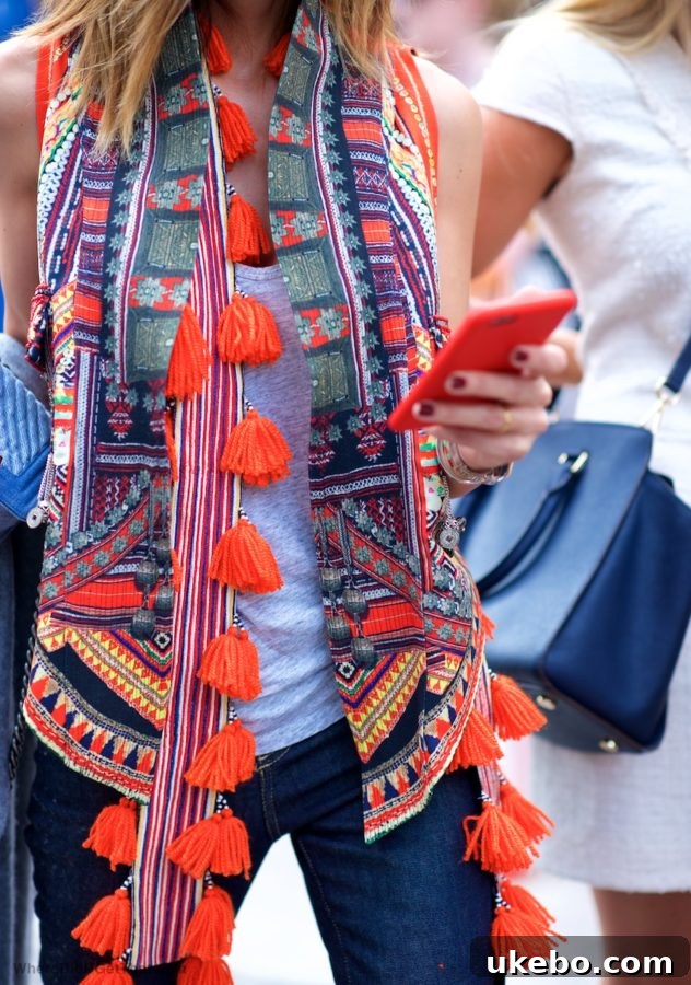 Stylish woman holding a handbag embellished with large, decorative tassels, showcasing a trendy fashion accessory that can inspire home decor choices.
