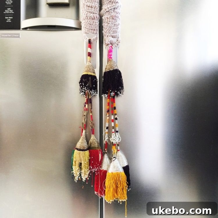 Close-up of a stylish handbag with multiple colorful tassels and pom-poms, showcasing a playful and elaborate design that inspires playful home accents.