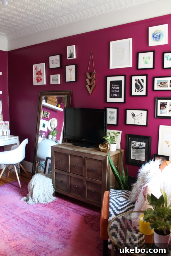 Megan's stylish and cozy living room with a deep pink accent wall and a comfortable sofa.