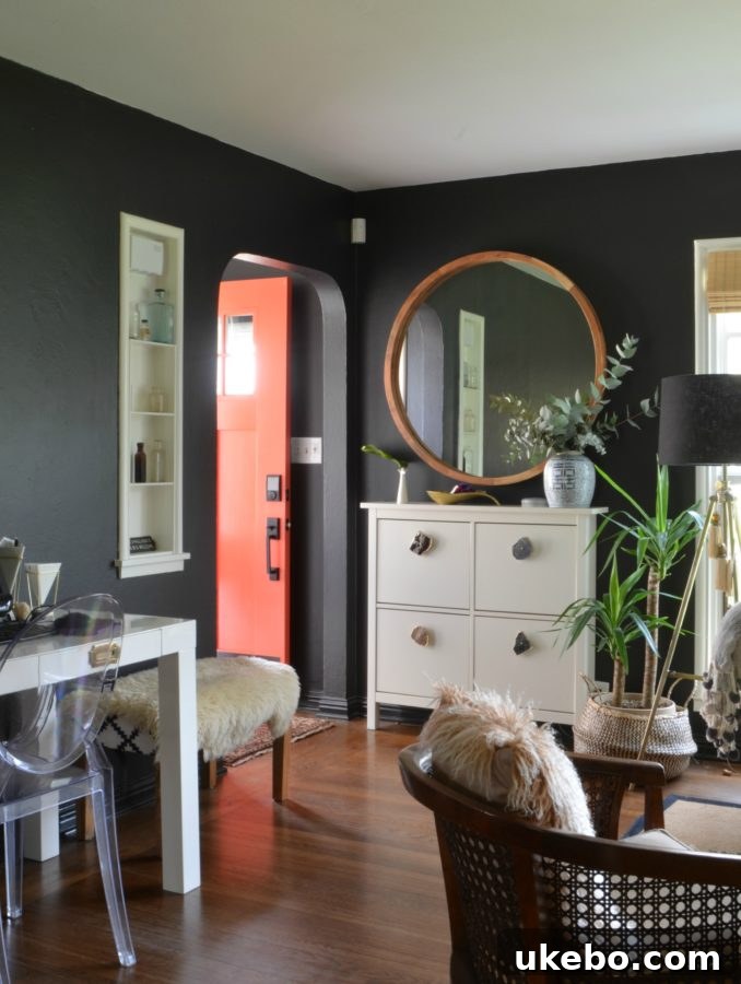 Living room perspective with black walls, sofa, and new lighting