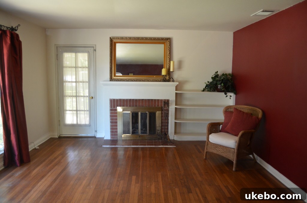 Original fireplace with faded red brick and brass details before renovation