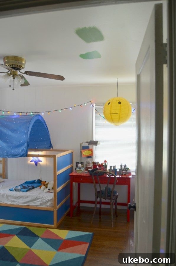 Another angle of the pre-makeover boy's room showing a cluttered space