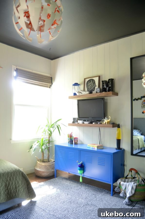 Detailed view of the black ceiling and new light fixture in the boy's room