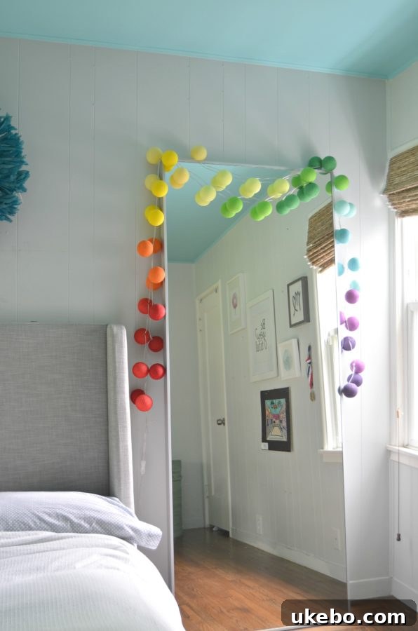 Bry's room featuring a cozy bed, minimalist mirror, and colorful string lights creating a warm ambiance.