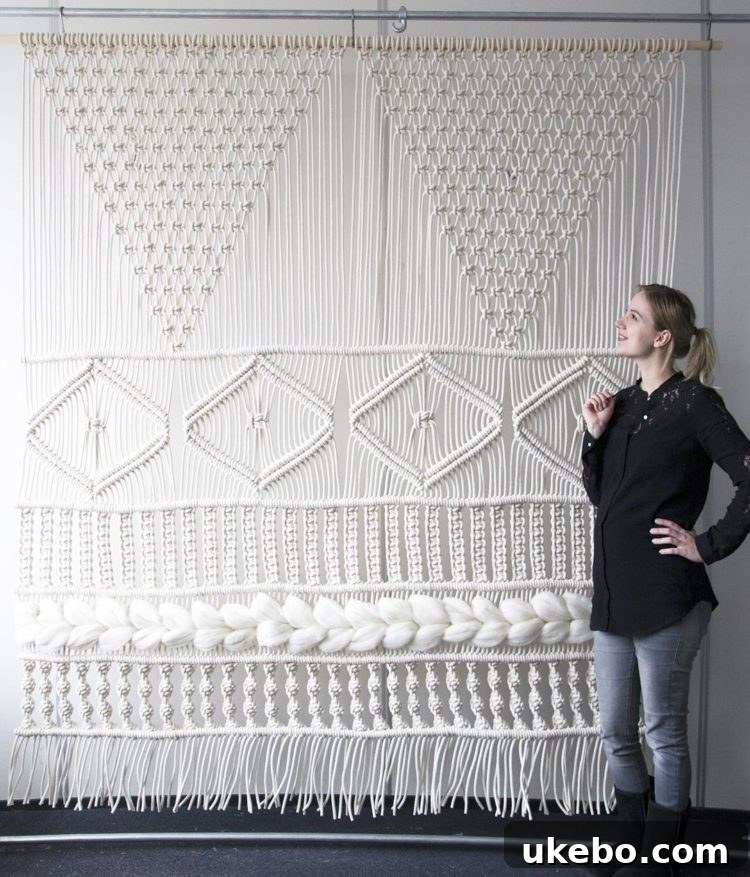 Large-scale macrame wall screen by Teddy and Wool, featuring a dramatic, expansive design with vibrant color accents.