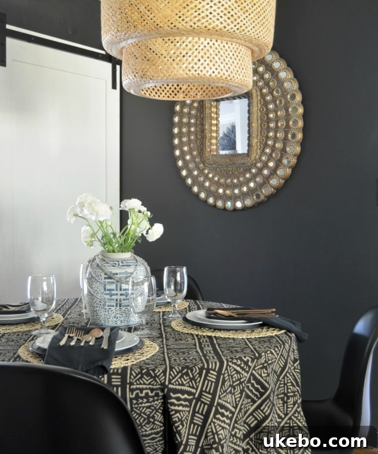 Dining table styled with mudcloth tablecloth, dishware, and flatware