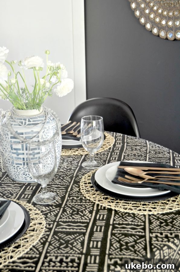 Close-up of table setting with water goblet and dish