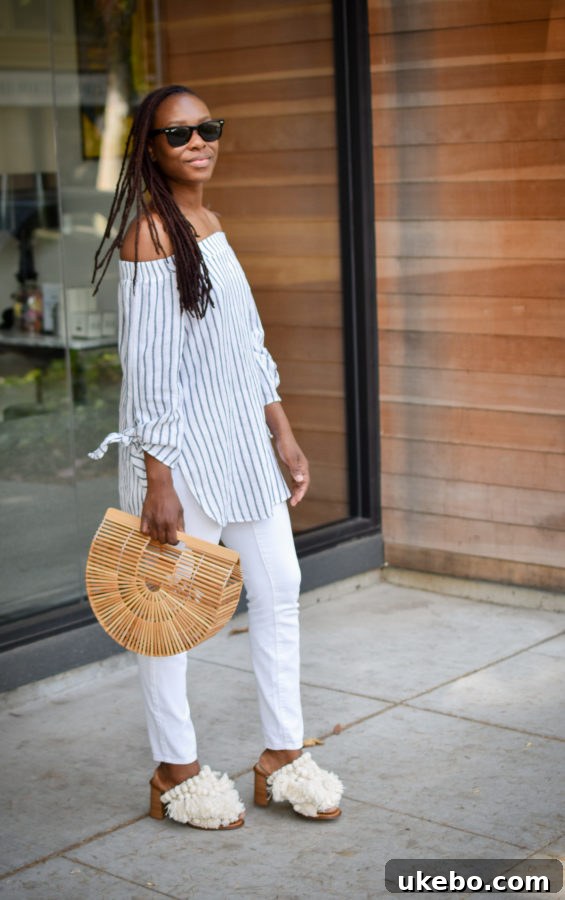Full body shot of Shavonda showcasing her spring/summer outfit with the Cult Gaia Ark Bag and Zara mules